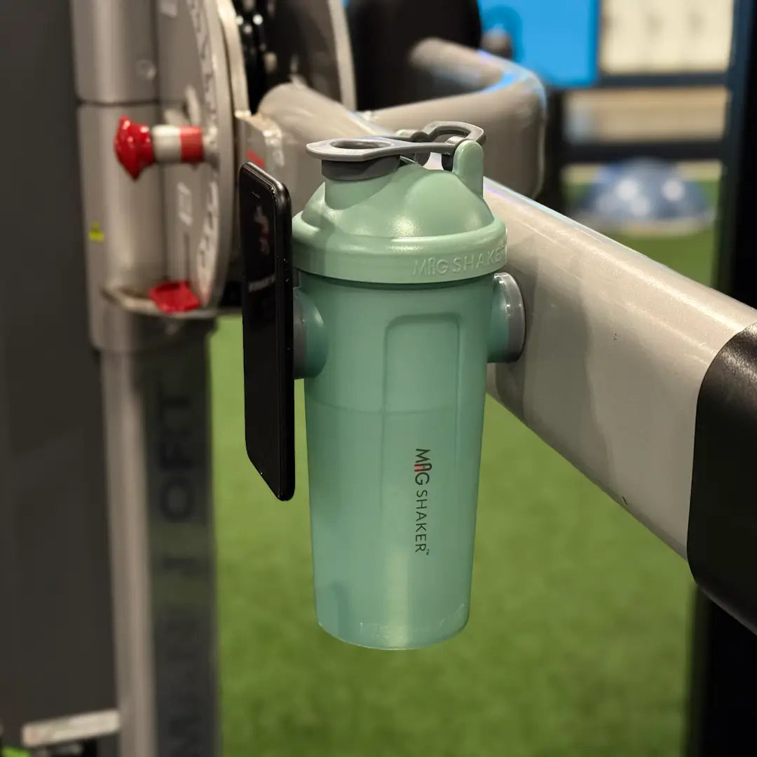 Phone mounted to Mag Shaker bottle while Mag Shaker is mounted on gym equipment